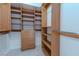 Walk-in closet providing ample storage with multiple shelves, drawers, and metal hanging bars at 2747 Paradise Rd # 2305, Las Vegas, NV 89109