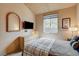 Bedroom with vaulted ceiling, dresser, and large window letting in natural light at 2808 Cygnus St, Las Vegas, NV 89117