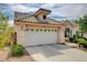 Charming single-story home featuring a two-car garage and desert landscaping with a mature tree at 2808 Cygnus St, Las Vegas, NV 89117