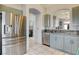 Modern kitchen with stainless steel appliances, sage cabinets, and tile flooring at 2808 Cygnus St, Las Vegas, NV 89117