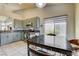 Bright kitchen featuring stainless steel appliances, gray cabinets, and an eat-in dining area at 2808 Cygnus St, Las Vegas, NV 89117