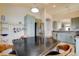Well-lit kitchen with stainless steel appliances, gray cabinets, and a dark wooden dining table at 2808 Cygnus St, Las Vegas, NV 89117