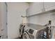 Functional laundry room with white cabinets, silver washer and dryer, and an ironing board at 2808 Cygnus St, Las Vegas, NV 89117