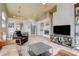 Open-concept living room with fireplace, tile flooring, and views to the kitchen at 2808 Cygnus St, Las Vegas, NV 89117