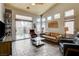 Bright living room with a vaulted ceiling, comfortable seating, and sliding glass doors leading outside at 2808 Cygnus St, Las Vegas, NV 89117