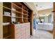 Spacious walk-in closet leading to a bathroom featuring custom shelves and ample storage at 2808 Cygnus St, Las Vegas, NV 89117