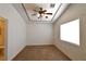 Carpeted bedroom with ceiling fan, a large window, and decorative trim on the ceiling at 2839 Kensington St, Las Vegas, NV 89156
