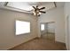 Bedroom featuring ceiling fan, large window, neutral paint, and a mirrored closet doors at 2839 Kensington St, Las Vegas, NV 89156