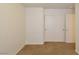 This bedroom features neutral walls and carpet flooring, along with closet and door access at 2839 Kensington St, Las Vegas, NV 89156
