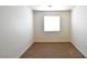 This cozy bedroom features neutral walls, carpet flooring, and a bright window at 2839 Kensington St, Las Vegas, NV 89156
