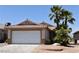 Charming single-story home featuring a two-car garage, desert landscaping, and a tile roof at 2839 Kensington St, Las Vegas, NV 89156