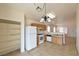 Cozy kitchen featuring tile flooring, wood cabinets, white appliances, and an adjacent pantry area at 2839 Kensington St, Las Vegas, NV 89156