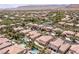 An aerial view showcasing a well-maintained neighborhood with lush greenery, pools, and tile-roofed houses at 2846 Barrow Downs St, Las Vegas, NV 89135