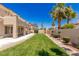 Beautiful backyard view featuring well-manicured lawn, lush landscaping, and a covered patio at 2846 Barrow Downs St, Las Vegas, NV 89135