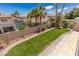 Lush backyard with manicured lawn, mature trees, and privacy fencing at 2846 Barrow Downs St, Las Vegas, NV 89135