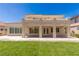 Stunning backyard view featuring a covered patio with classic columns and a well-maintained lawn at 2846 Barrow Downs St, Las Vegas, NV 89135