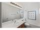 Clean bathroom with combination tub and shower featuring a large mirror at 2846 Barrow Downs St, Las Vegas, NV 89135