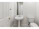 Powder room with a pedestal sink and toilet at 2846 Barrow Downs St, Las Vegas, NV 89135