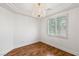 Cozy bedroom with hardwood flooring, plantation shutters, and a chandelier at 2846 Barrow Downs St, Las Vegas, NV 89135