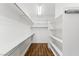 Organized walk-in closet features wooden floor and white shelving at 2846 Barrow Downs St, Las Vegas, NV 89135