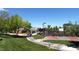 Community park with walking path and basketball court among the mature trees and lush landscaping at 2846 Barrow Downs St, Las Vegas, NV 89135