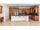Modern kitchen with stainless appliances, custom cabinets, and center island provides ample cooking space at 2846 Barrow Downs St, Las Vegas, NV 89135
