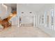Open-concept living area featuring winding staircase, marble floors, and ample natural light at 2846 Barrow Downs St, Las Vegas, NV 89135