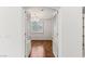 View through open doors into a living room with hardwood flooring and a chandelier at 2846 Barrow Downs St, Las Vegas, NV 89135