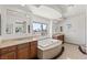 Elegant main bathroom features soaking tub, dual sinks, and natural light from windows at 2846 Barrow Downs St, Las Vegas, NV 89135