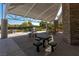 Shaded picnic area with stone pillars, multiple tables, and nearby green spaces at 2846 Barrow Downs St, Las Vegas, NV 89135
