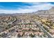A wide aerial shot showcases a residential neighborhood against a backdrop of mountains under a blue sky at 2913 Laverton Dr, Las Vegas, NV 89134