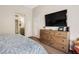 Bright and airy main bedroom features dresser, TV, and ensuite bathroom access at 2913 Laverton Dr, Las Vegas, NV 89134
