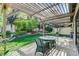 Inviting backyard patio with a shaded pergola, manicured lawn, and tranquil garden views at 3013 Plaza De Rosa, Las Vegas, NV 89102