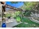 Charming backyard featuring a covered patio, lush greenery, and a serene outdoor space at 3013 Plaza De Rosa, Las Vegas, NV 89102