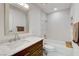 Modern bathroom featuring a vanity with marble countertop, tub, and decorative mirror at 3013 Plaza De Rosa, Las Vegas, NV 89102