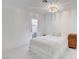 Bright bedroom with white walls, a glass door to the outside, and a decorative light fixture at 3013 Plaza De Rosa, Las Vegas, NV 89102
