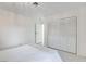 This bright bedroom features white walls, a marble floor, and a double door closet at 3013 Plaza De Rosa, Las Vegas, NV 89102