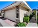 Home exterior featuring a two-car garage with manicured landscaping and a concrete walkway, and an address marker at 3013 Plaza De Rosa, Las Vegas, NV 89102