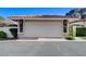 Exterior shot of the garage door showcasing the red tiled roof of this charming single-Gathering home at 3013 Plaza De Rosa, Las Vegas, NV 89102