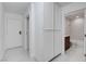 Hallway with closet leading to bathroom with bathtub and vanity at 3013 Plaza De Rosa, Las Vegas, NV 89102