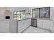 Open concept kitchen with stainless appliances and stone accent wall at 3013 Plaza De Rosa, Las Vegas, NV 89102
