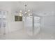 Open-concept living area featuring modern lighting, white walls, and seamless flow for entertaining at 3013 Plaza De Rosa, Las Vegas, NV 89102