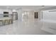 Open floor plan showing kitchen, living, and dining areas with marble floors at 3013 Plaza De Rosa, Las Vegas, NV 89102