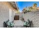 Outdoor patio with 2 chairs, a small table, and some colorful flowers at 3013 Plaza De Rosa, Las Vegas, NV 89102