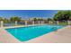 Sparkling community pool with lounge chairs and a view of the city skyline at 3013 Plaza De Rosa, Las Vegas, NV 89102