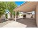The backyard patio is covered and has a concrete floor, there are some small trees at 3053 Anchor Chain Dr, Las Vegas, NV 89128
