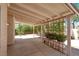 A backyard patio covered by a wooden roof. The backyard has some trees and planters at 3053 Anchor Chain Dr, Las Vegas, NV 89128