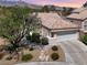 Charming single-story home with a tile roof, mature landscaping, and a two-car garage at 3053 Anchor Chain Dr, Las Vegas, NV 89128