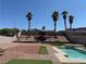 Beautiful backyard featuring a refreshing pool, lush landscaping, and a serene outdoor space at 341 Waterwheel Falls Dr, Henderson, NV 89015