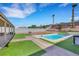 Inviting backyard with sparkling pool, lush landscaping, and relaxing hot tub at 341 Waterwheel Falls Dr, Henderson, NV 89015